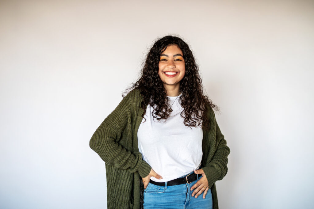 Young woman in casual clothing standing and smiling